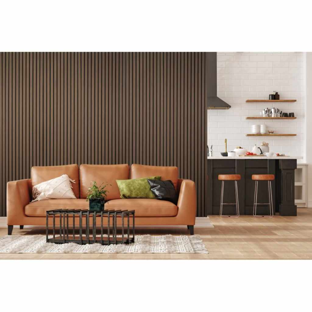 Dark oak acoustic wall paneling behind a tan leather sofa in a modern living room setting.