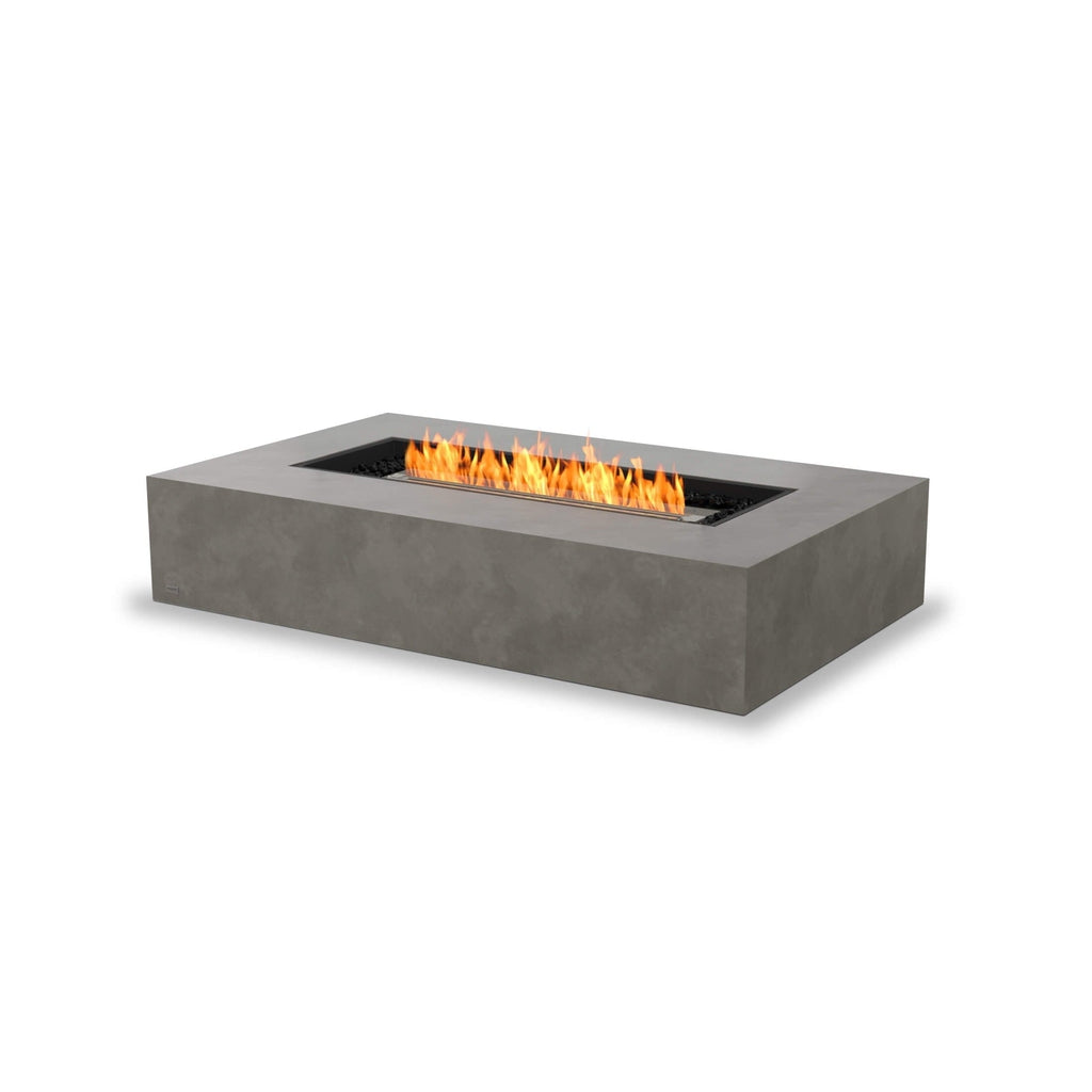 EcoSmart Fire Wharf 65 ethanol fire pit table in grey concrete with a rectangular flame and black decorative stones.