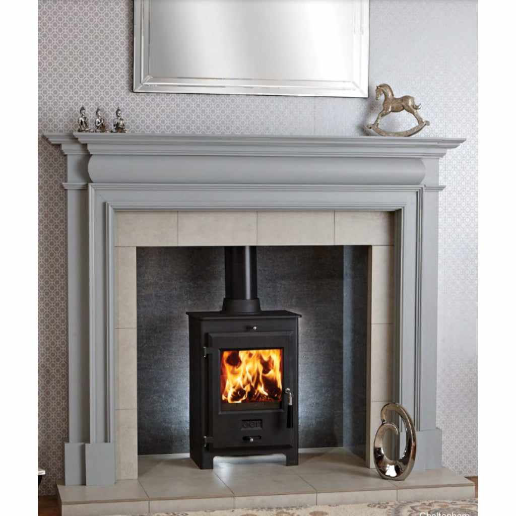 OER 5 MultiFuel 5KW stove in black, set within a grey traditional fireplace surround with a lit fire.