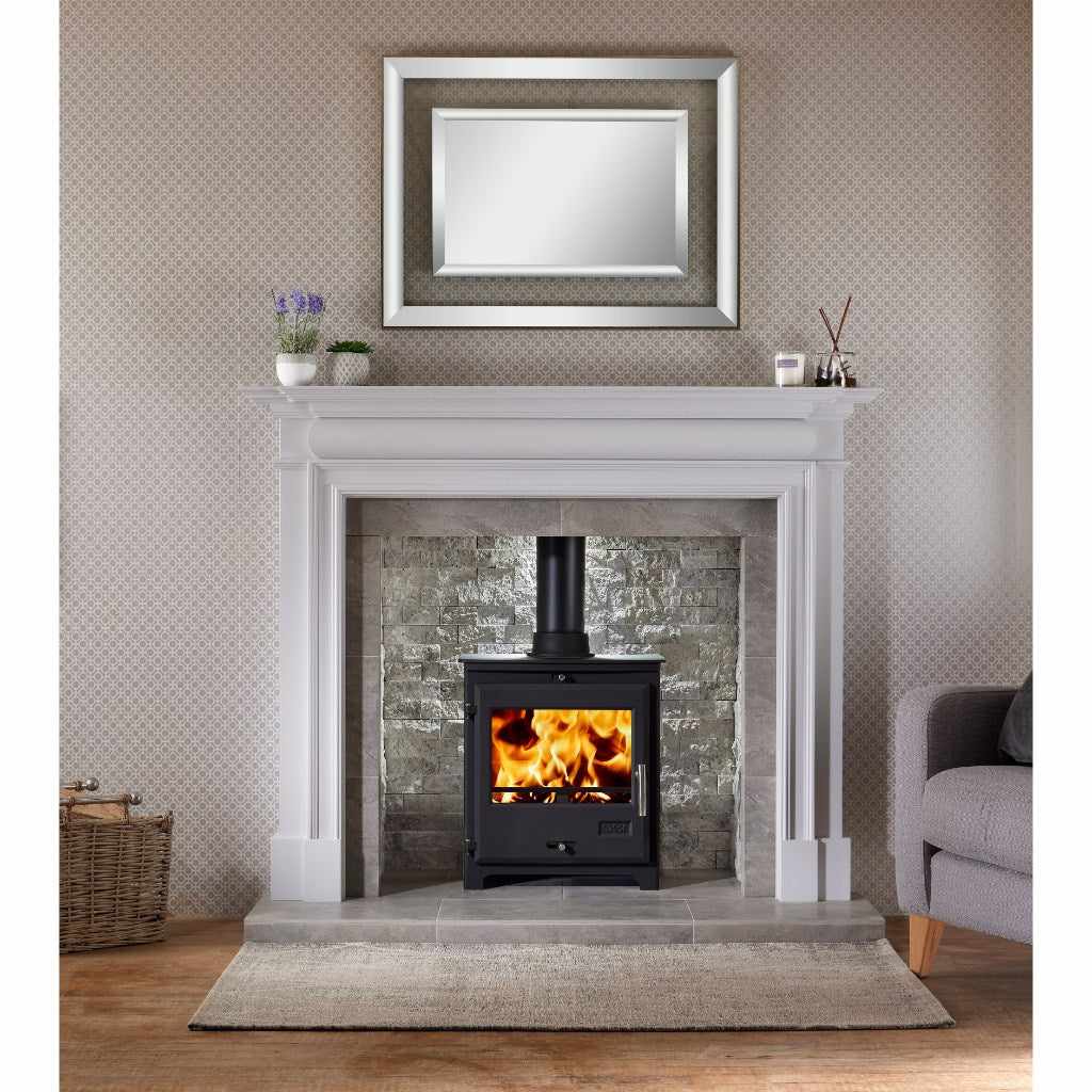 OER 8 MultiFuel 8KW wood burning stove in black, set within a white mantelpiece and grey stone fireplace surround.