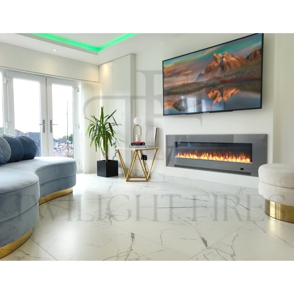 Aurora 60 Inch Media Wall Electric Fire Insert with a grey glass frame and realistic flames in a modern white living room.