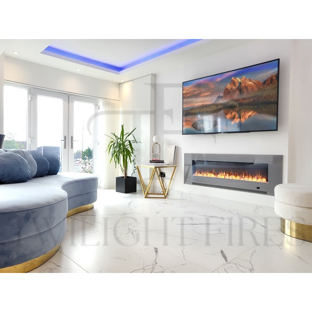 Aurora 60 Inch Media Wall Electric Fire Insert with a grey glass frame and glowing flames in a modern white living room.