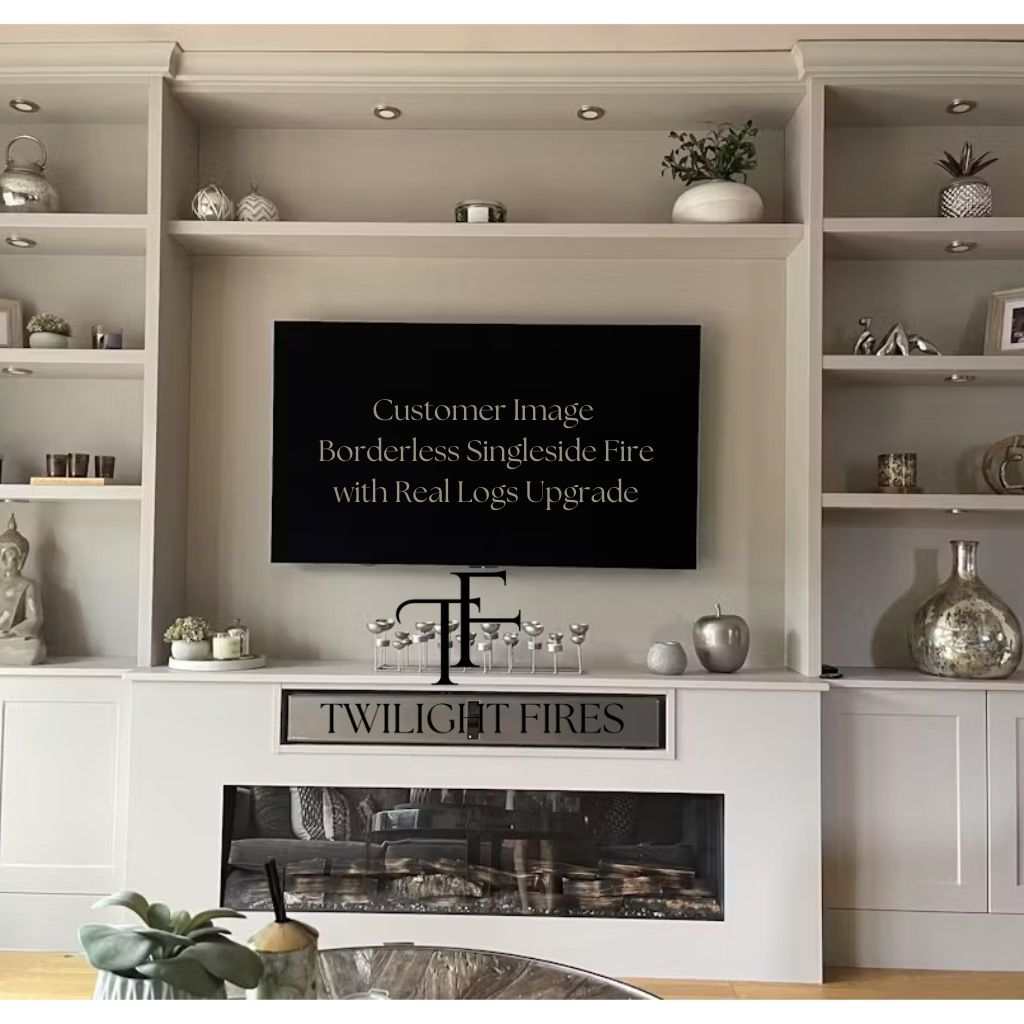 Borderless full glass electric fire recessed in a white media wall with integrated shelving and real log fuel bed.