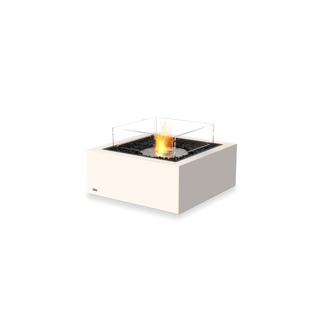 EcoSmart Fire Base 30 bioethanol fire pit in cream with black lava rocks and a square glass wind screen.