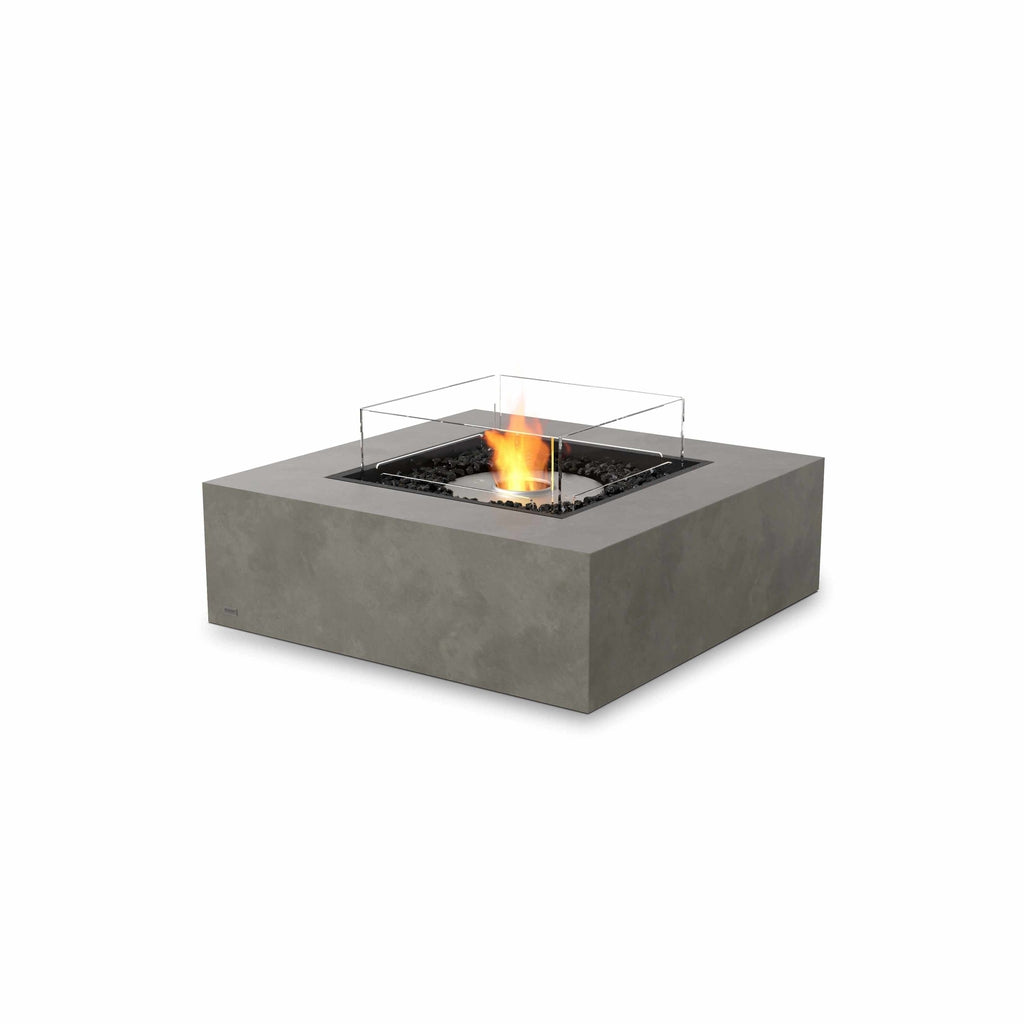 EcoSmart Fire Base 40 bioethanol fire pit table in grey concrete with a square glass screen and central flame.