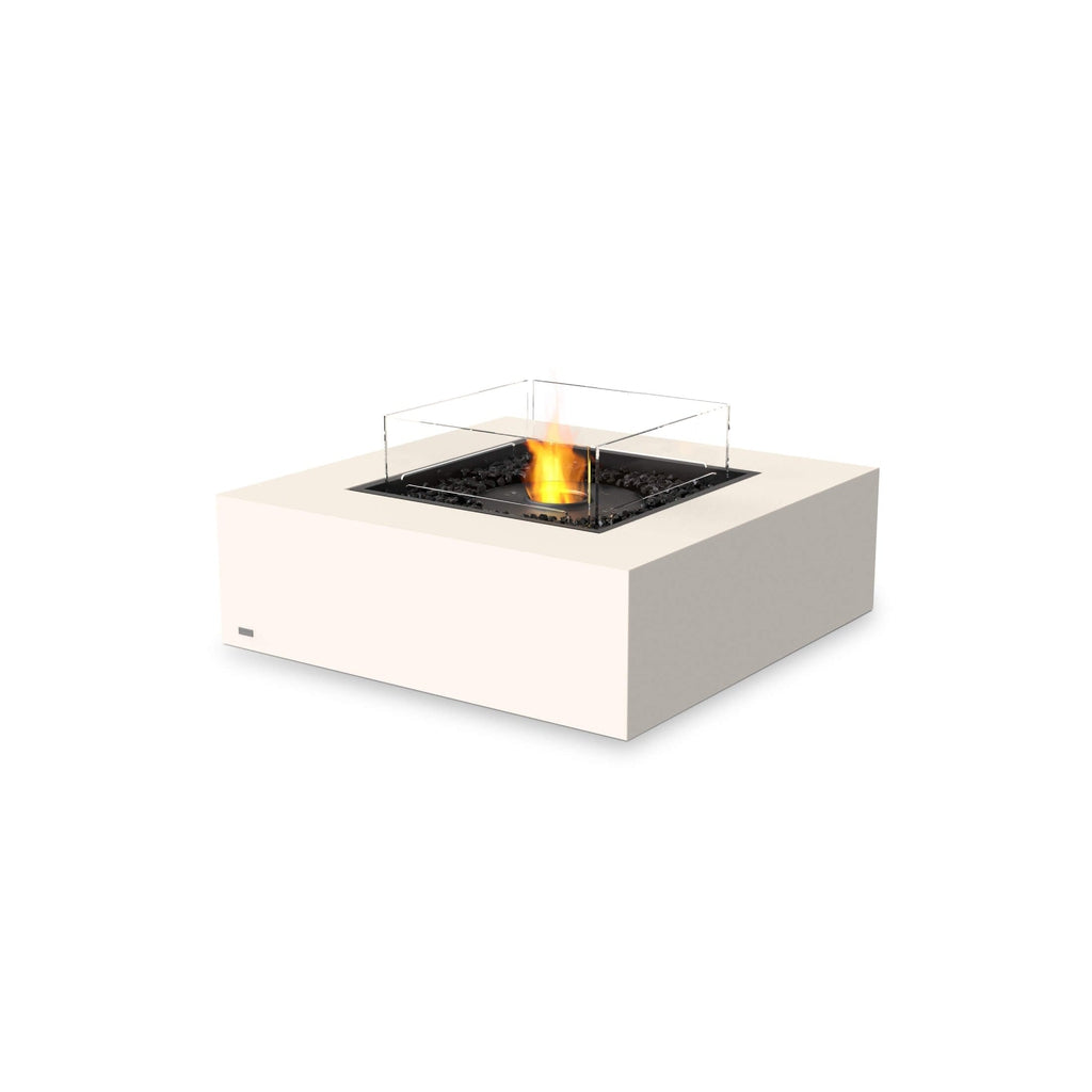EcoSmart Fire Base 40 bioethanol fire pit table in cream with a glass screen and black decorative stones.