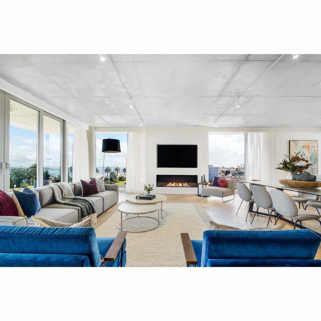 EcoSmart Fire Flex 68 bioethanol fireplace insert installed in a white wall below a television in a modern living room.