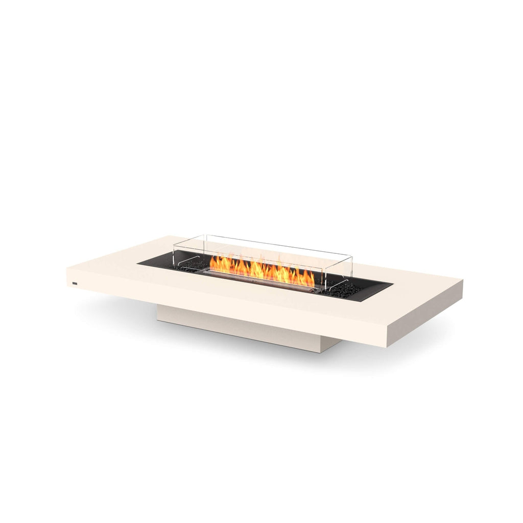 EcoSmart Fire Gin 90 low rectangular cream fire pit table with a central burner, glass screen and black lava rocks.