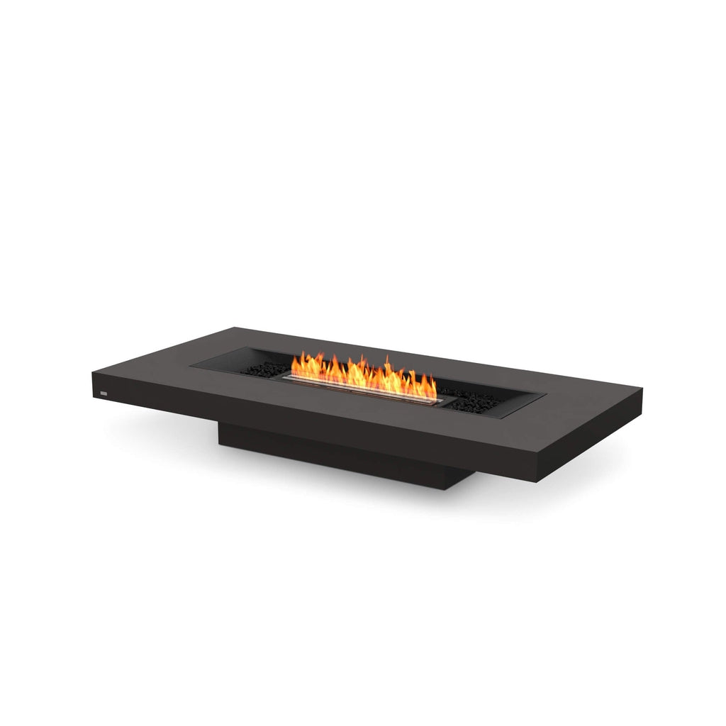 EcoSmart Fire Gin 90 low rectangular black bioethanol fire pit table with a central linear flame and black stones.