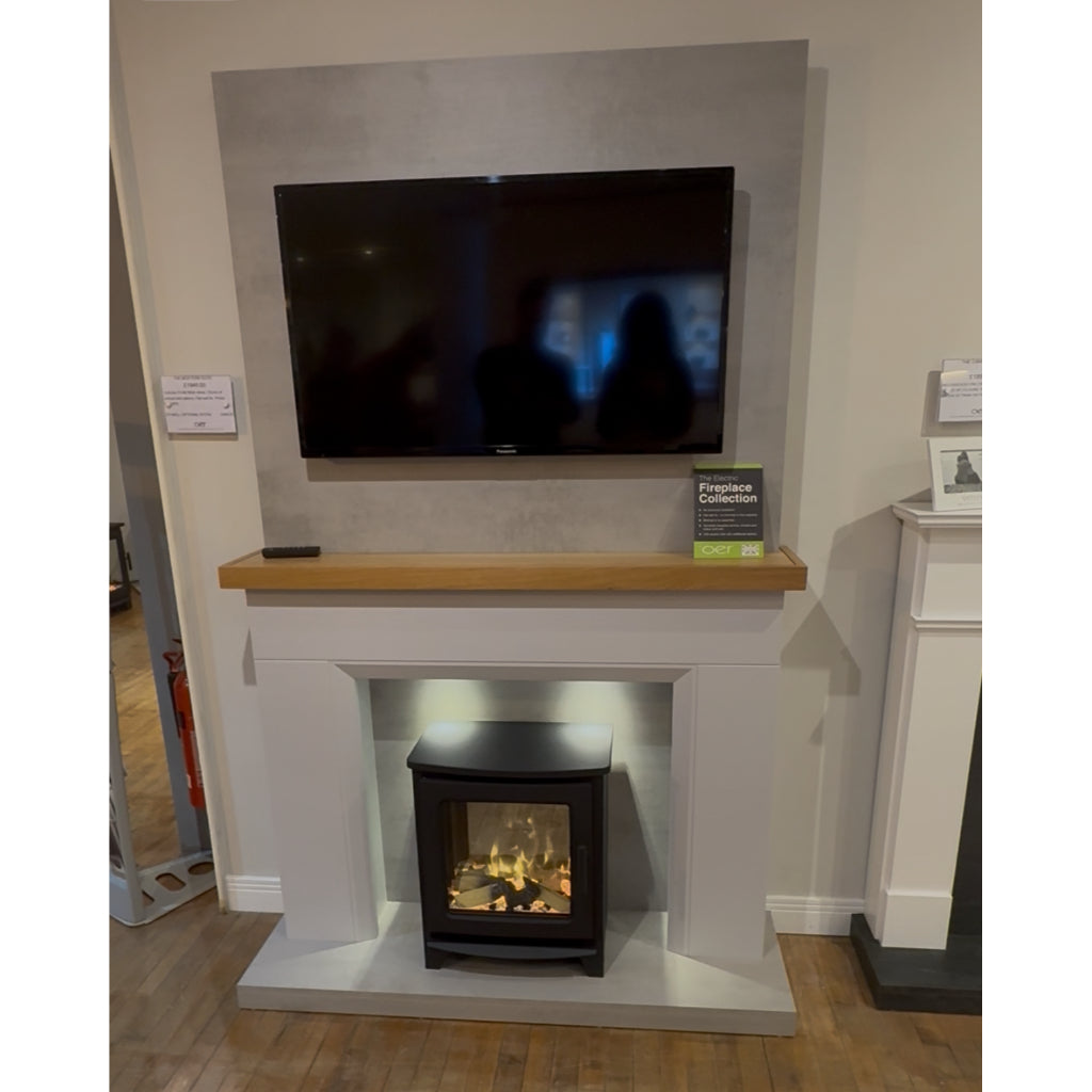 Firetti New York electric stove suite with a grey surround, oak mantel, and black stove set against a concrete panel.