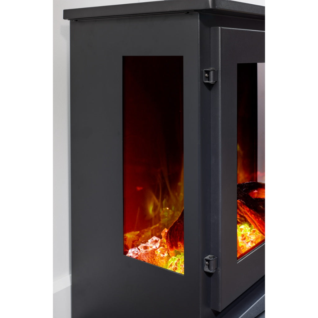 Flametek Trio 3-Sided Electric stove with a matte black finish, glass side panels, and glowing crystal fuel bed.