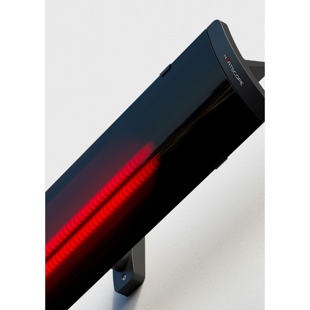 Heatscope Heaters Pure+ 3000W electric heater in black with a glowing red heating element mounted on a white wall.