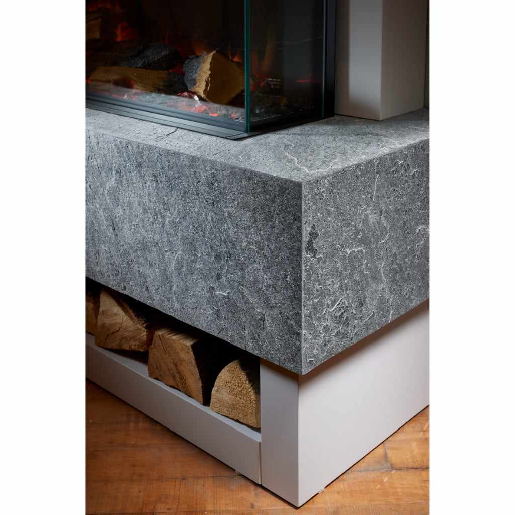 OER Icon Electric Fireplace suite featuring a grey textured stone hearth with a log storage shelf and glass firebox.