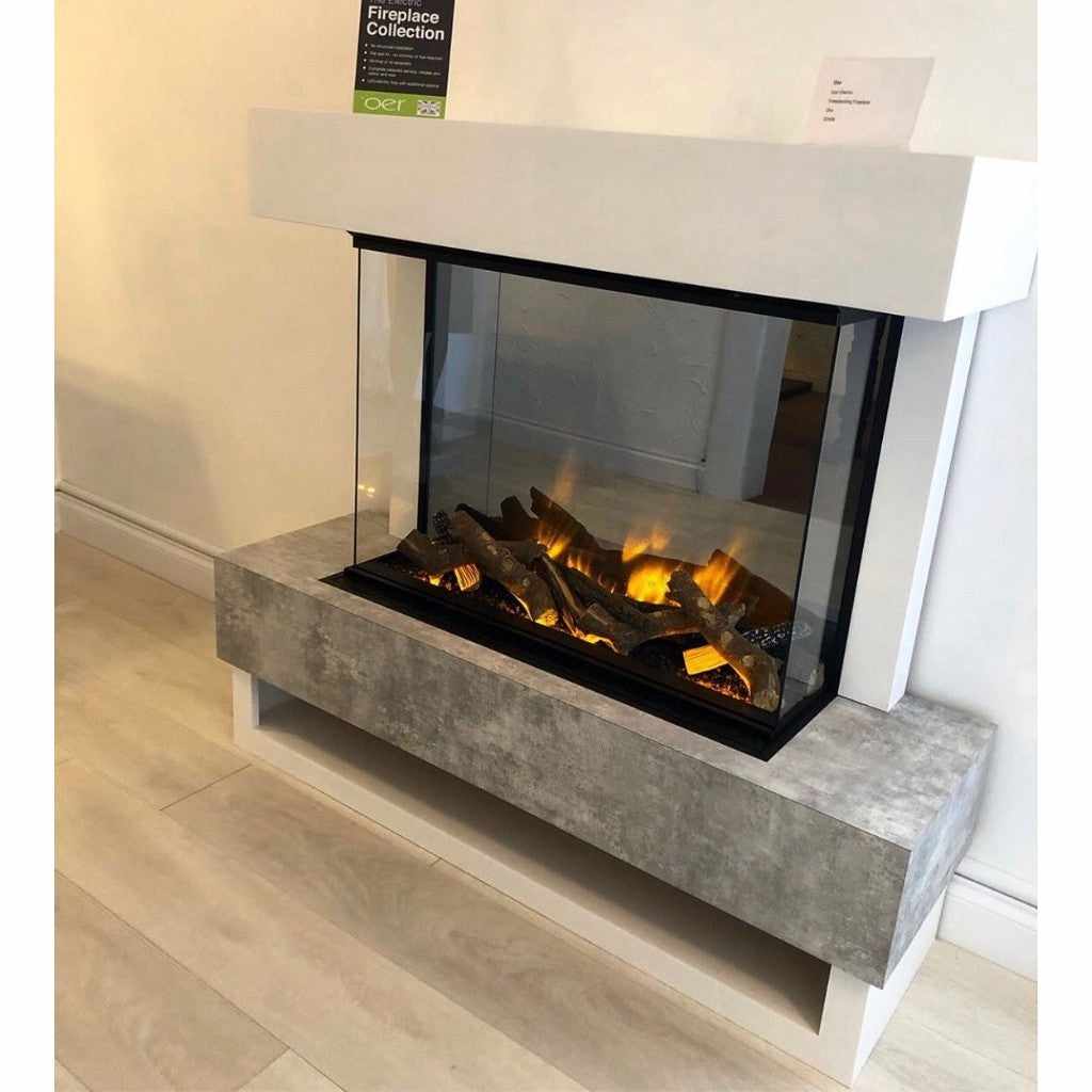 OER Icon Electric Fireplace suite with a white mantel, concrete-effect base, and three-sided glass fire display.