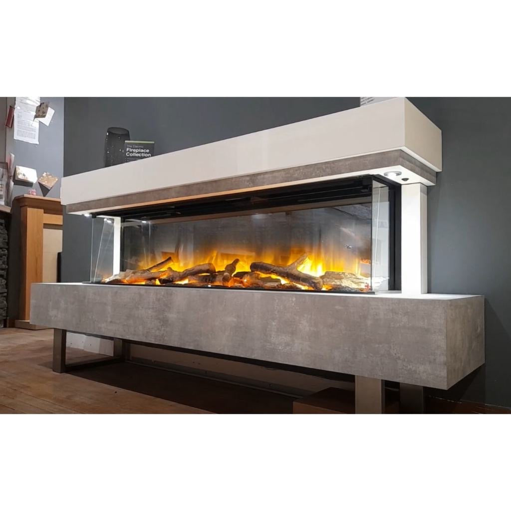 OER Olympia 1500 electric fireplace with a concrete-effect base, white mantel, and three-sided glass flame display.