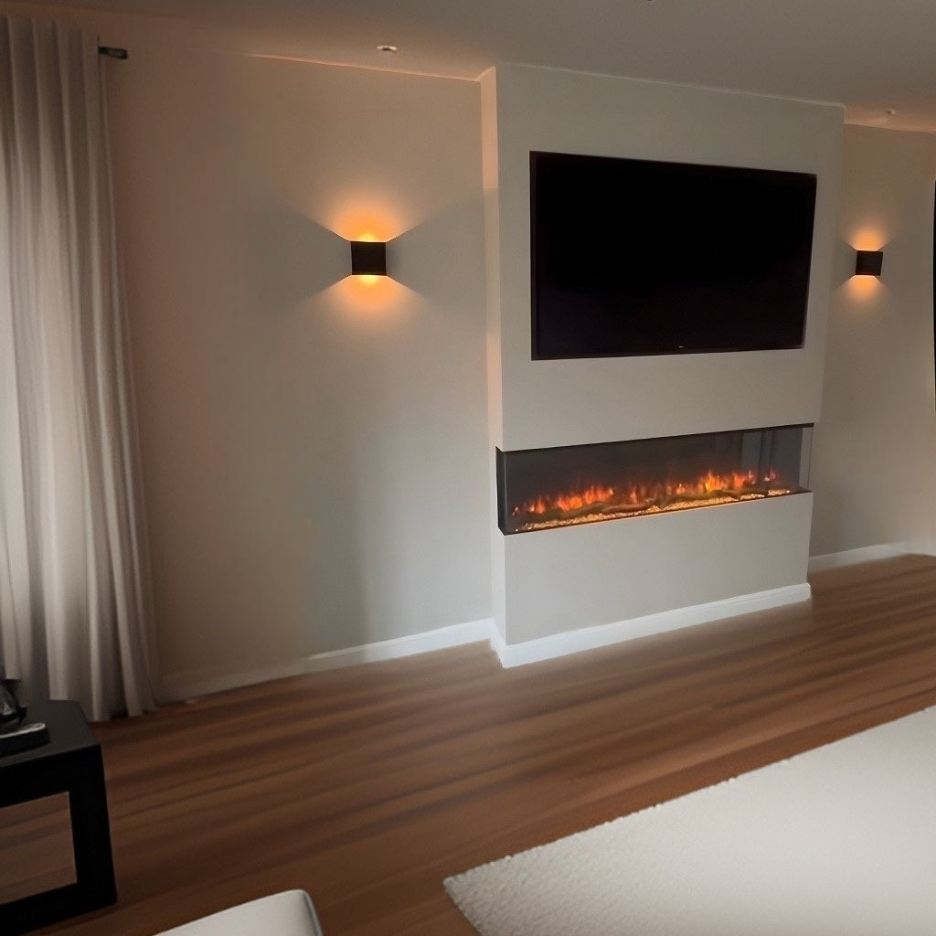 Slimline panoramic 3D electric fire integrated into a cream media wall with a mounted TV and warm wall lighting.