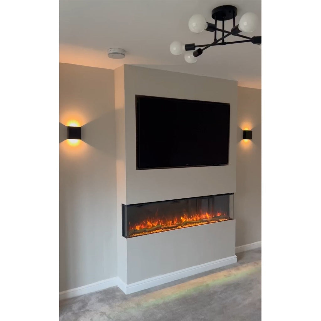 Slimline panoramic 3D electric fire installed in a beige media wall below a wall-mounted television.