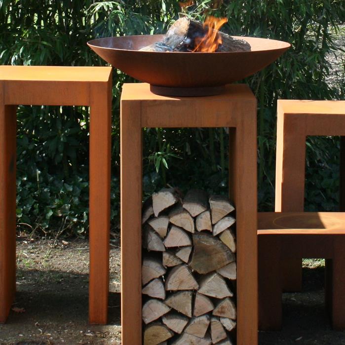 60cm Corten steel firepit bowl with a lit fire, resting on a tall, rust-coloured stand with log storage underneath.