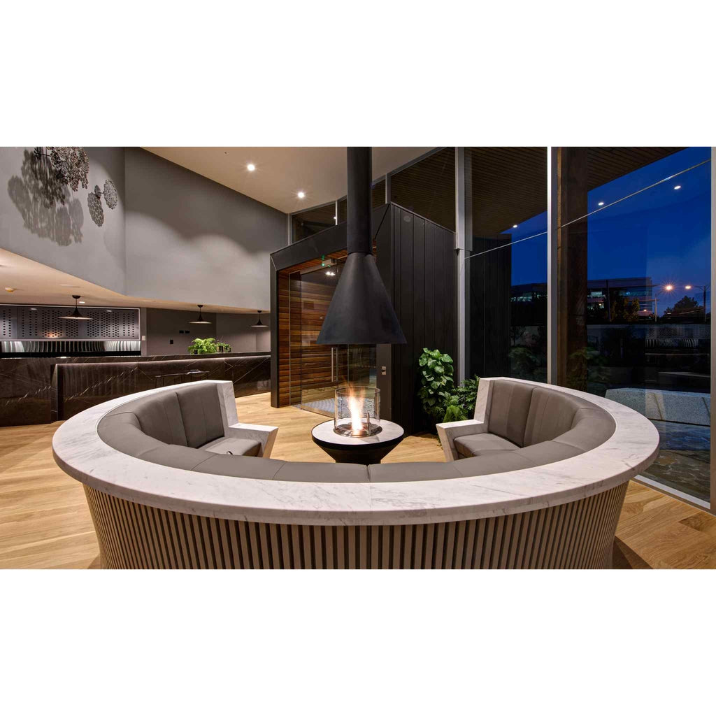 EcoSmart Fire AB3 ethanol burner with a glass surround, set within a circular marble-topped seating area.