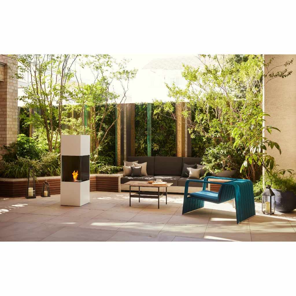 EcoSmart Fire BE bioethanol fireplace in a white finish on a modern patio with garden seating.
