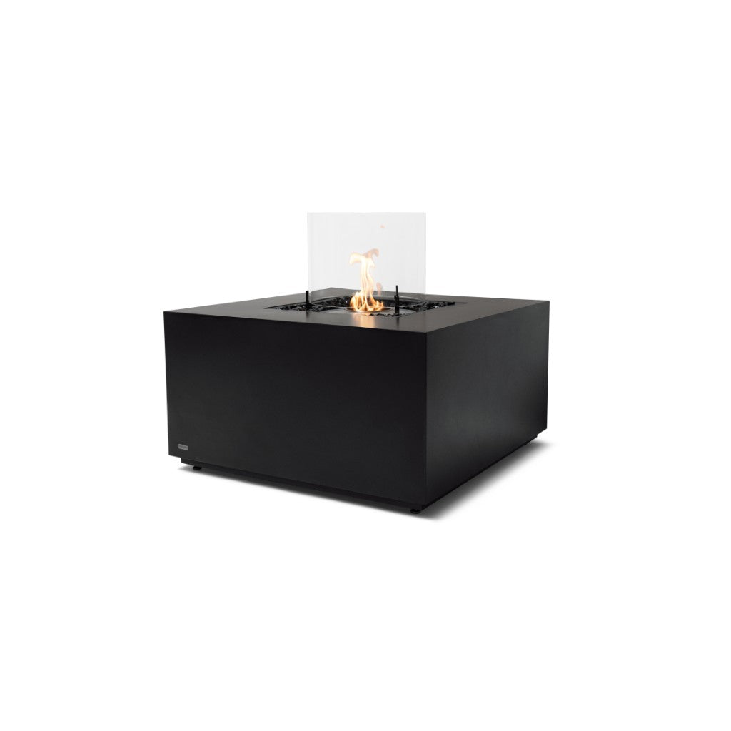 EcoSmart Fire Chaser 38 bioethanol fire pit table in matte black with a central flame and glass wind guard.