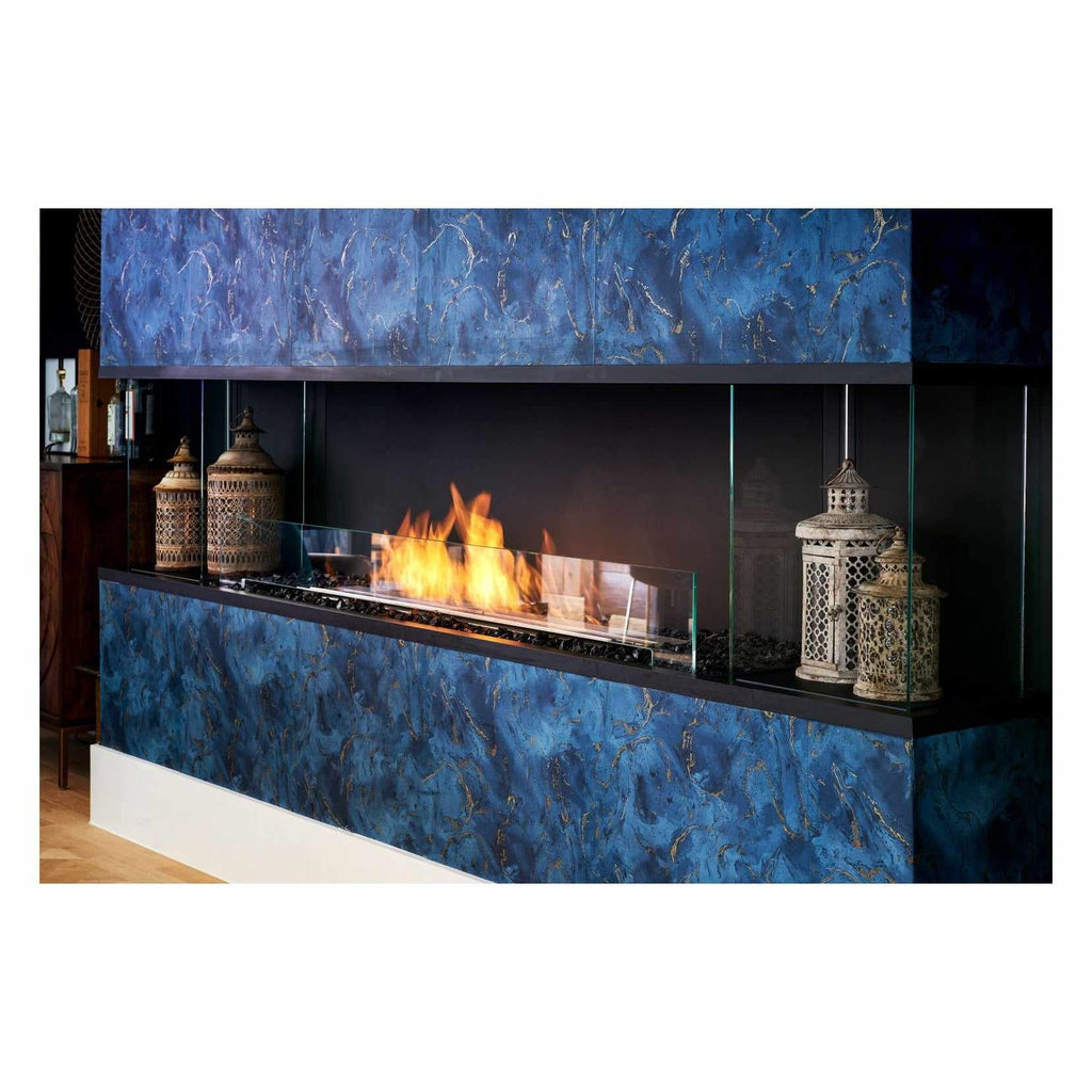 EcoSmart Fire Flex 104 bioethanol fireplace with a blue marble-effect surround, glass panels, and decorative lanterns.