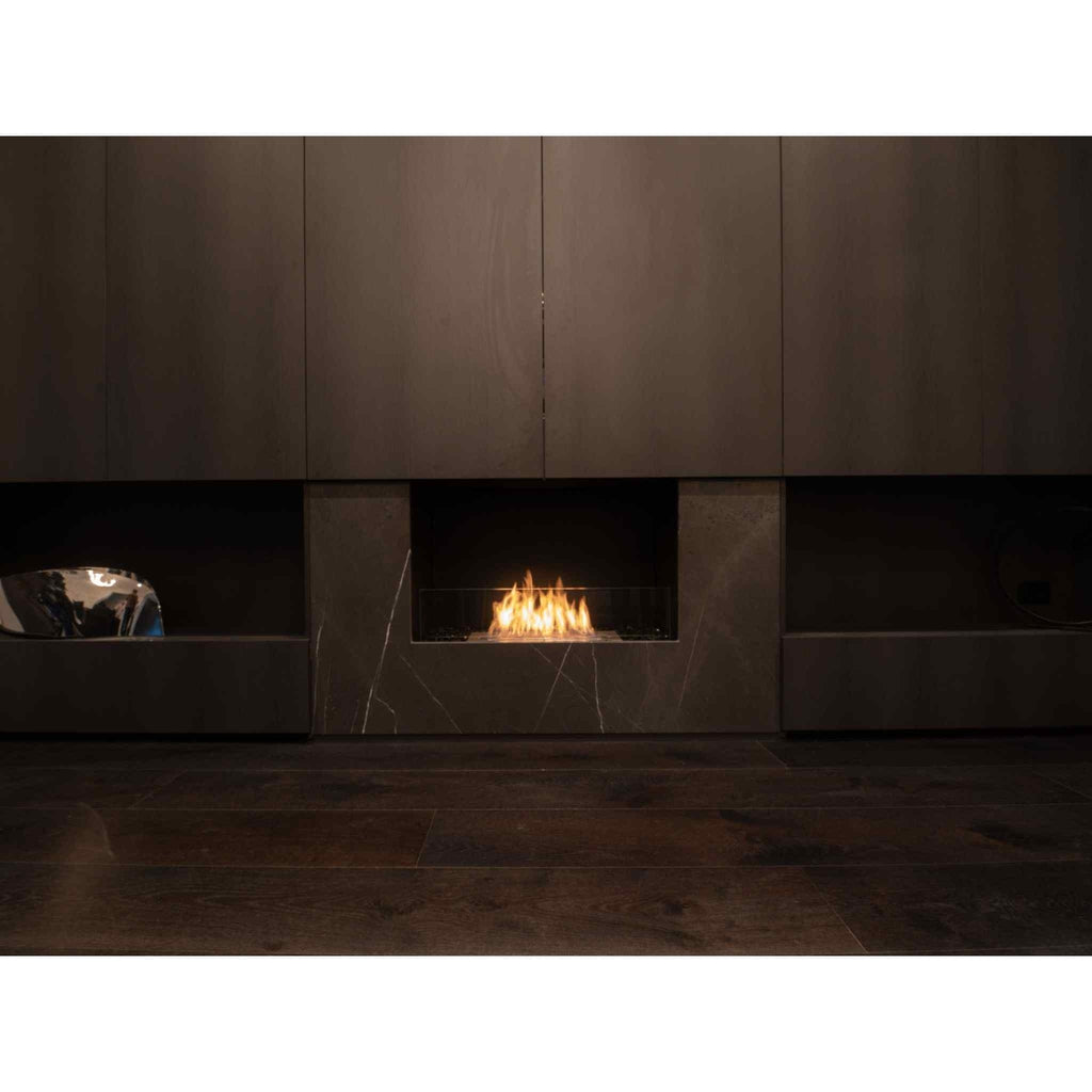 EcoSmart Fire Flex 32 bioethanol fireplace insert with a flickering flame set in a dark marble wall with wood flooring.