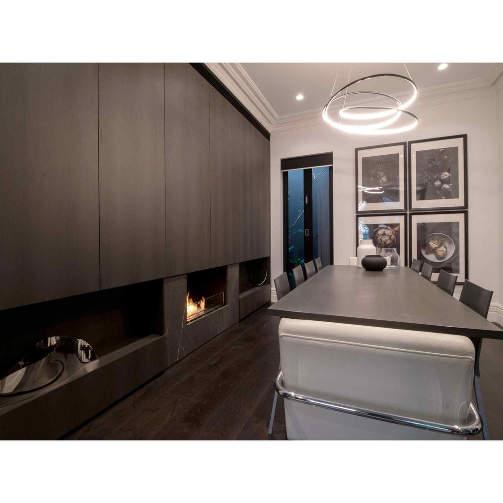 EcoSmart Fire Flex 32 bioethanol fireplace insert set into a dark wood feature wall in a modern dining room.