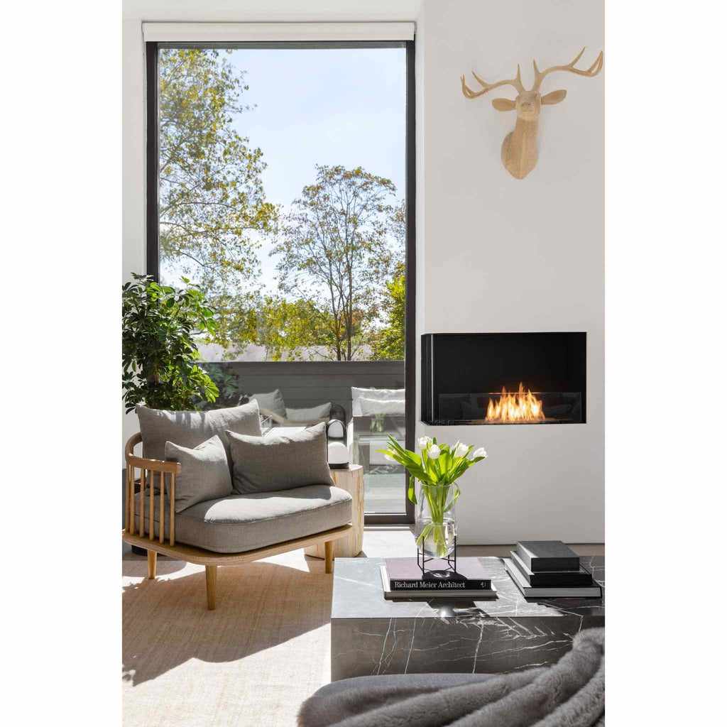 EcoSmart Fire Flex 32 bioethanol fireplace insert with a black frame and visible flames in a modern living room.