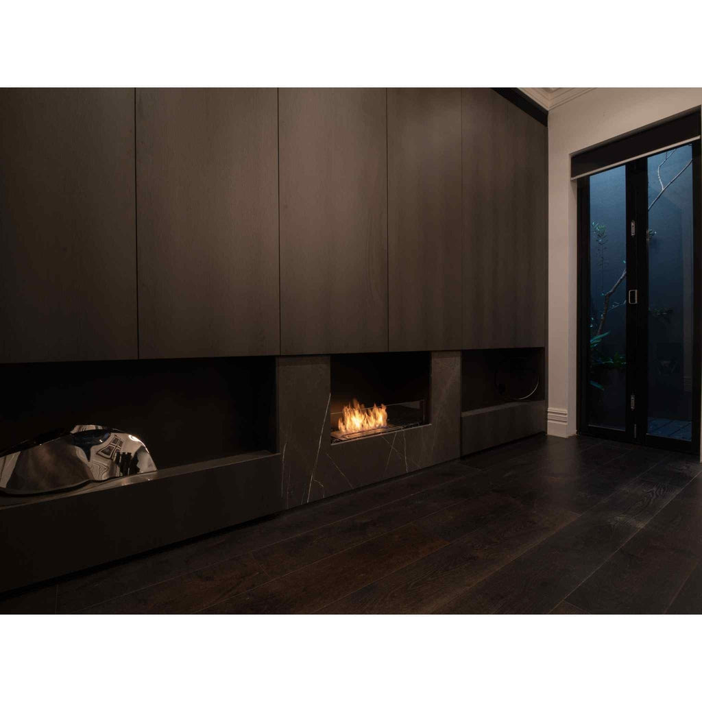 EcoSmart Fire Flex 32 bioethanol fireplace insert set in a dark marble surround with integrated cabinetry.