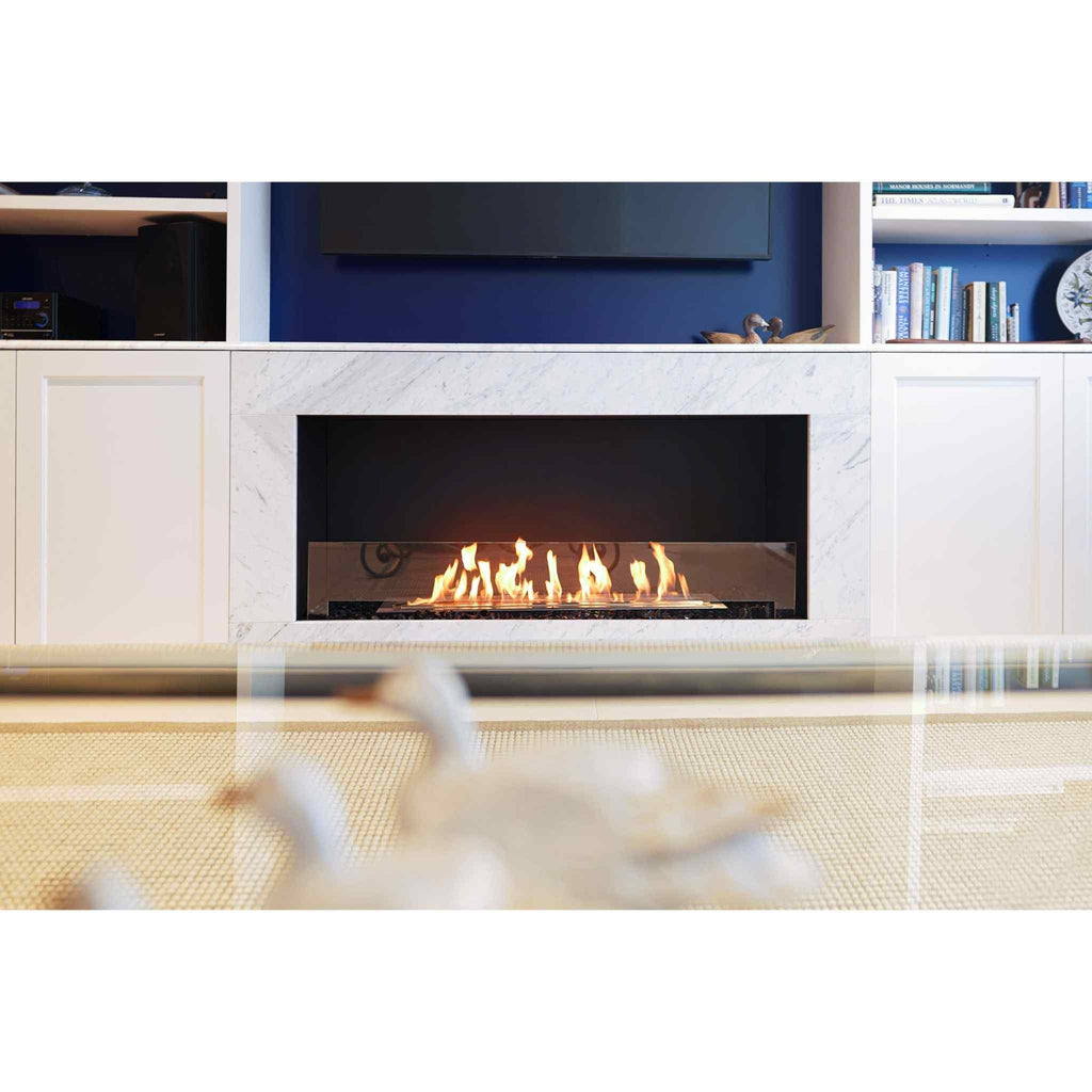 EcoSmart Fire Flex 50 bioethanol fireplace with a white marble surround set in a blue wall unit.