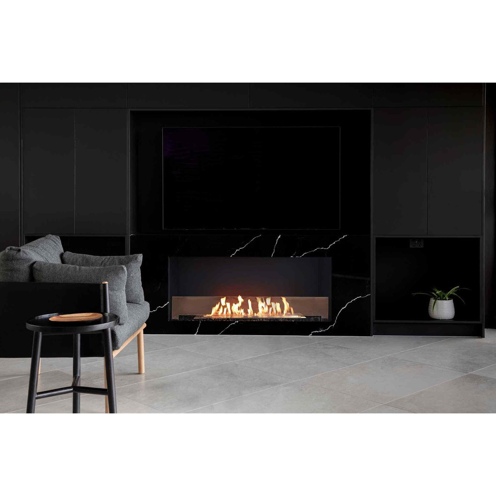 EcoSmart Fire Flex 50 bioethanol fireplace set into a black marble wall with a television above in a modern room.