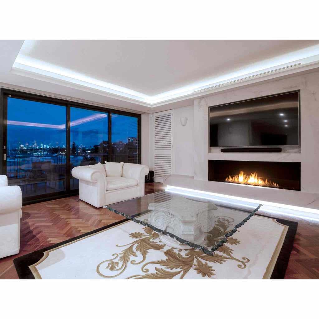 EcoSmart Fire Flex 60 bioethanol fireplace insert installed in a white marble wall below a television in a modern lounge.