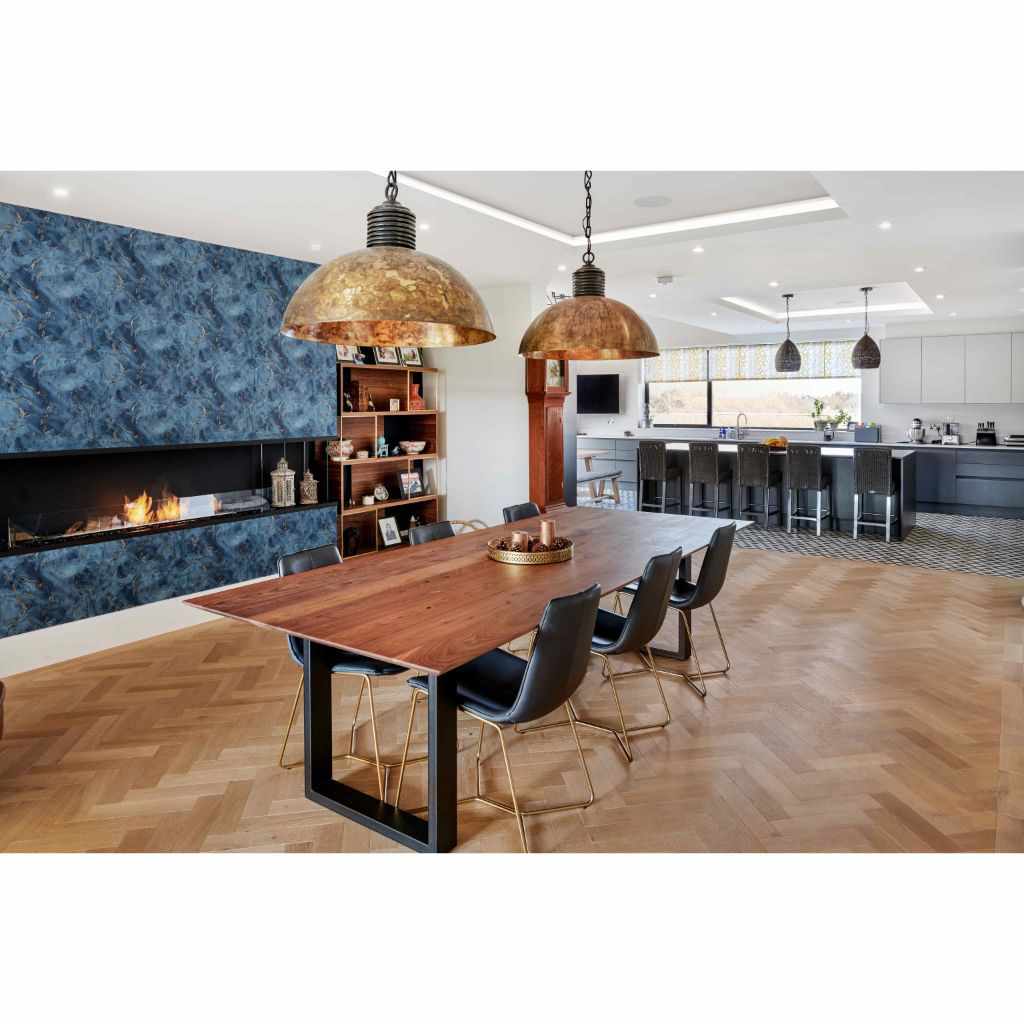 EcoSmart Fire Flex 86 bioethanol fireplace insert set into a blue marble-effect wall in a modern dining room.