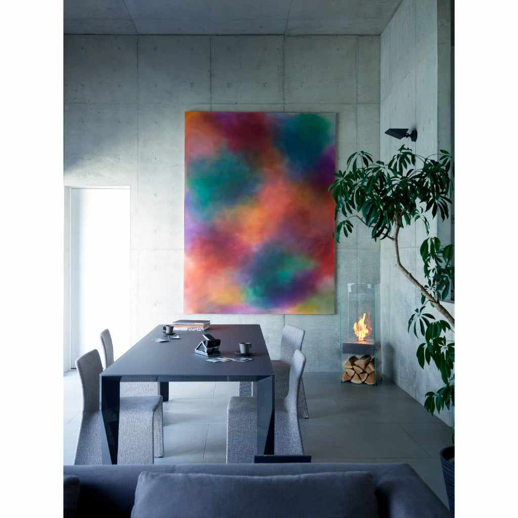 EcoSmart Fire Ghost bioethanol fireplace with a glass frame and flickering flame in a modern concrete dining room.