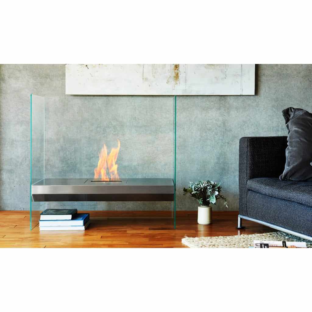 EcoSmart Fire Igloo bioethanol fireplace with a stainless steel burner and clear glass sides in a modern living room.