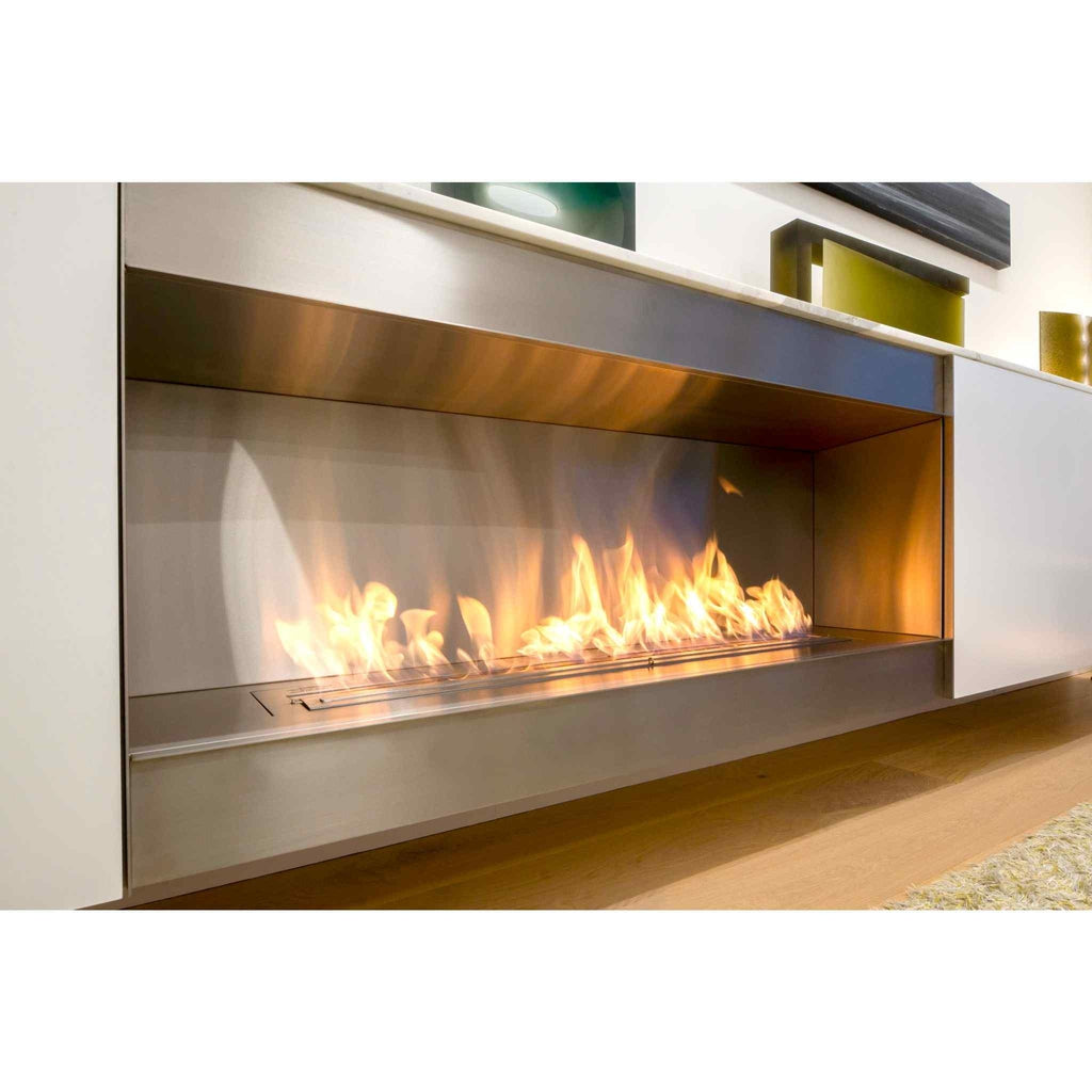 EcoSmart Fire XL1200 ethanol burner with a long, flickering flame set in a modern brushed stainless steel fireplace.