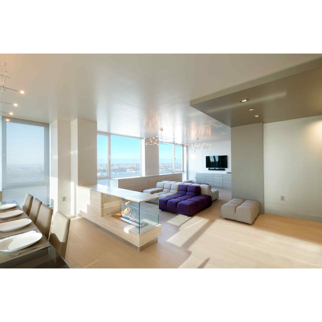 EcoSmart Fire XL900 ethanol burner integrated into a modern, light-wood room divider in a bright, open-plan apartment.