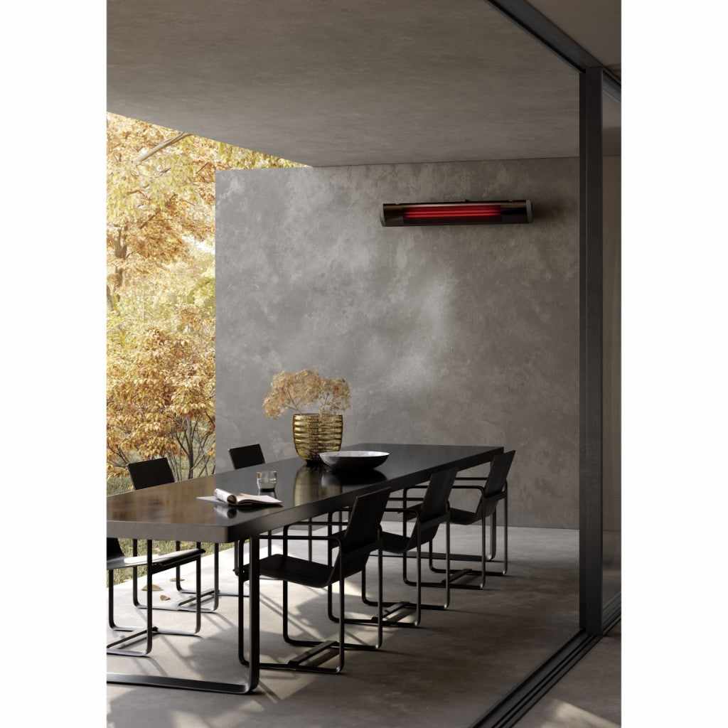 Heatscope Heaters Pure 2400W electric radiant heater mounted on a grey wall above a modern outdoor dining set.