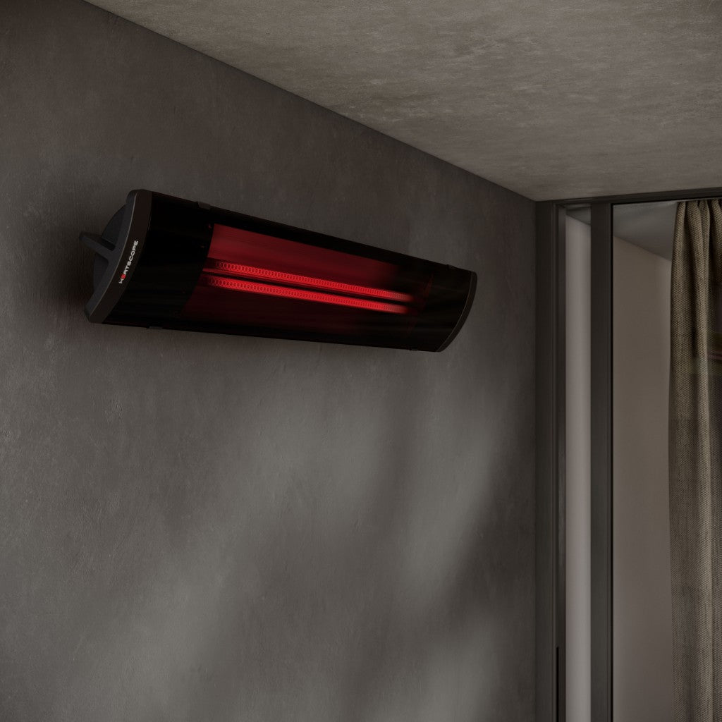 Heatscope Heaters Pure 3000W electric radiant heater in black, wall-mounted with a glowing red heating element.