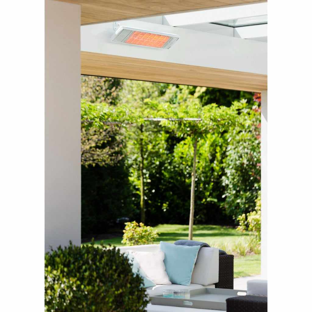 White Heatscope Heaters Spot 2800W electric radiant heater mounted on a ceiling above a garden patio.