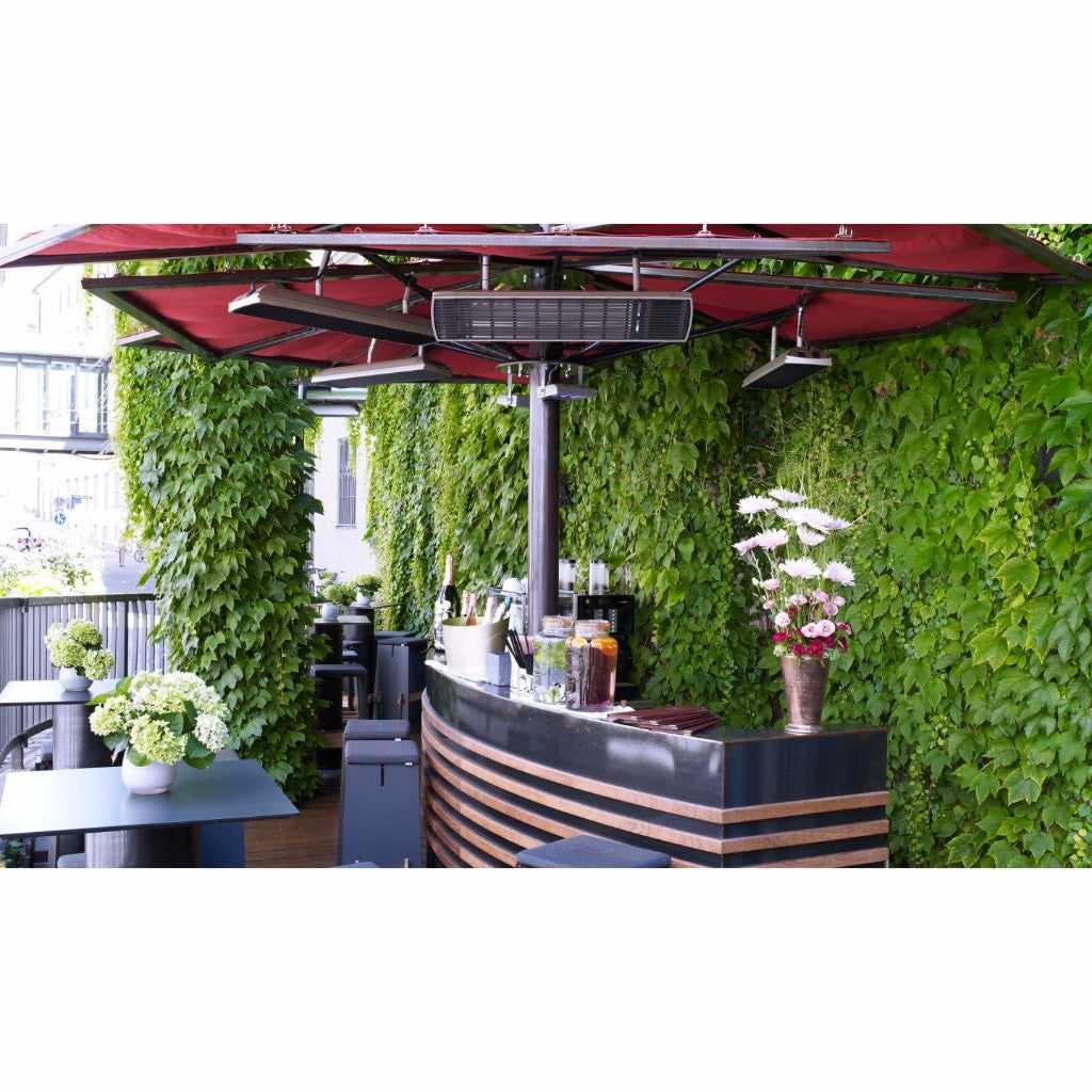 Heatscope Heaters Spot 2800W electric radiant heater mounted under a red outdoor parasol above a bar area.