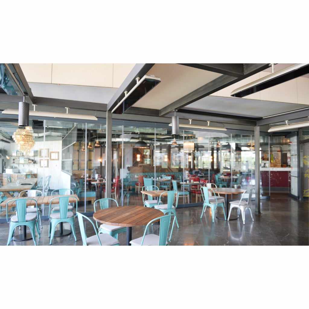 Heatscope Heaters Vision 3200w electric radiant heater mounted on a dark ceiling in a modern restaurant dining area.