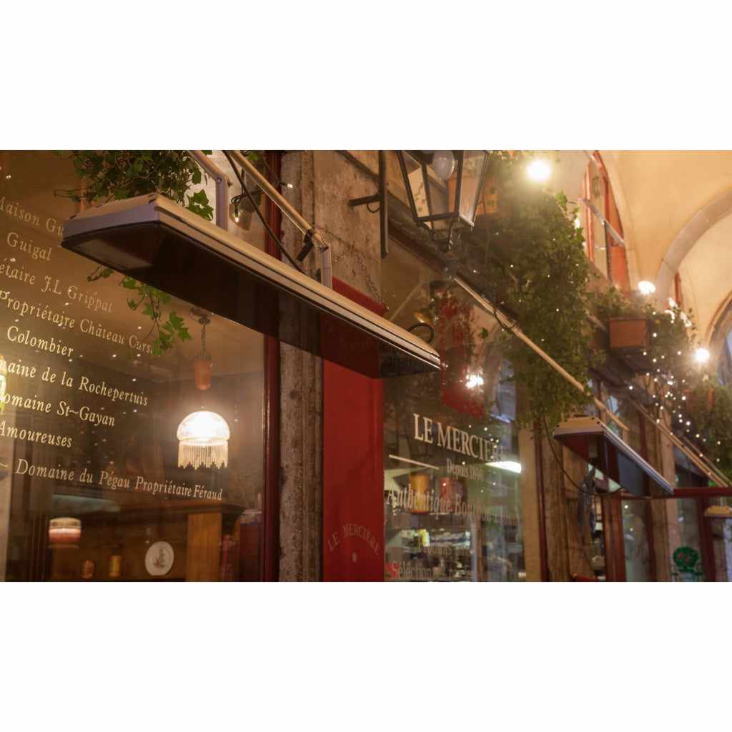Heatscope Heaters Vision 3200w electric radiant heater mounted above a restaurant window with a black glass finish.
