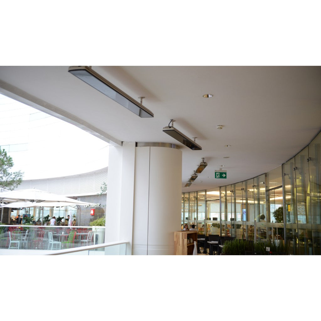 Heatscope Heaters Vision 3200w electric radiant heaters mounted in a row on a white ceiling in a modern cafe.