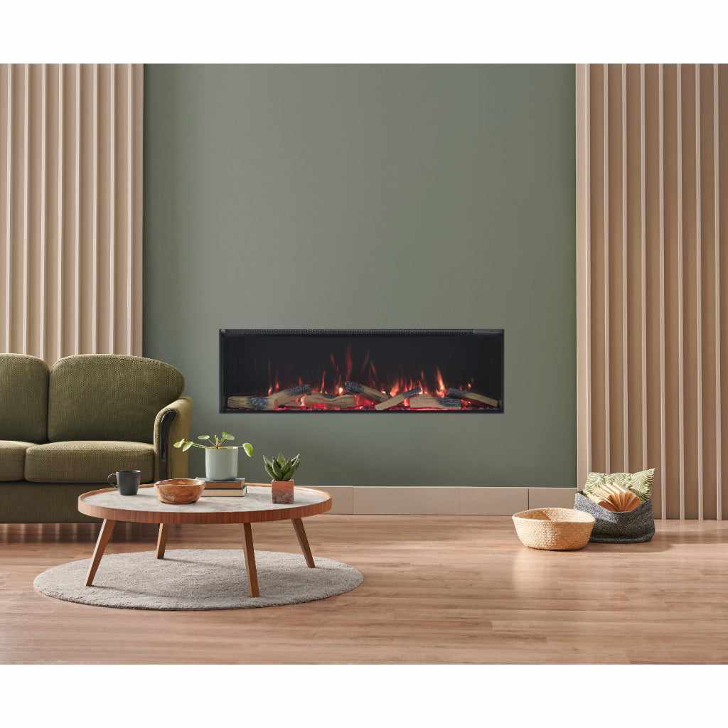 Vision Futura 1300 electric fire with realistic glowing logs set into a sage green media wall with wood slat panels.