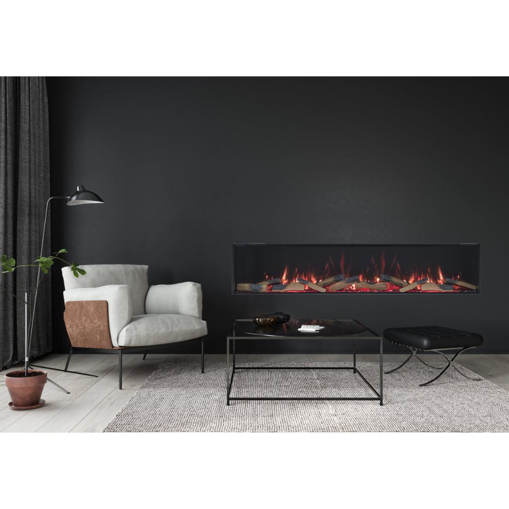 Vision Futura 72 inch electric fire with realistic glowing logs, set into a modern black wall in a lounge interior.