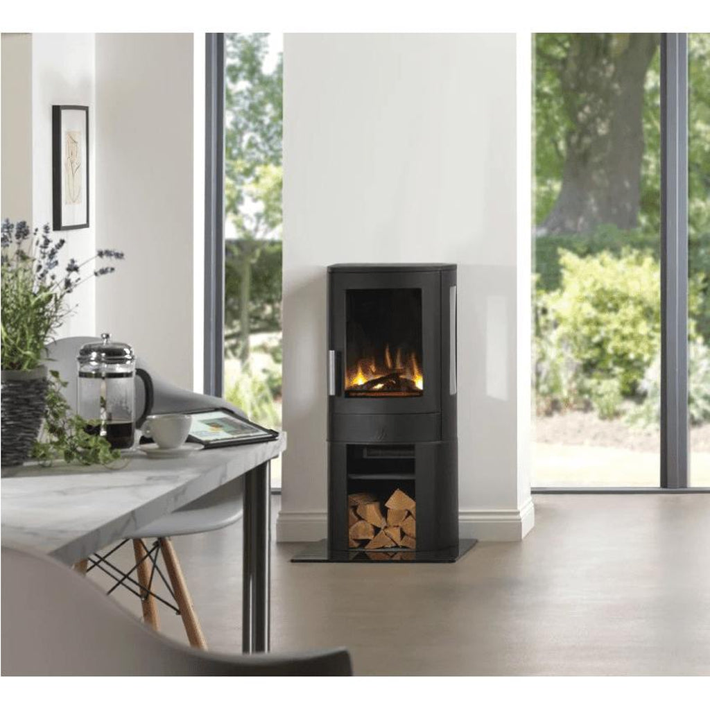 ACR NEO3C electric stove in black with a glass door, flame effect, and log storage compartment in a bright room.