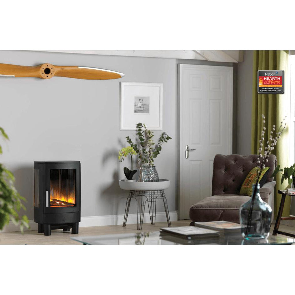ACR NEO3F electric stove with black finish and glass side panels, featuring a glowing flame effect in a living room.