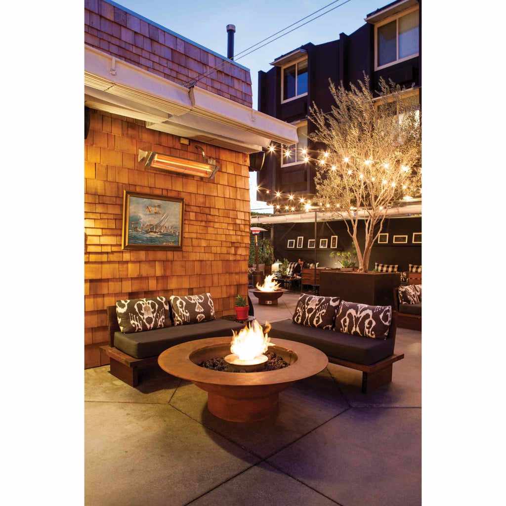 EcoSmart Fire AB8 Ethanol Burner with top tray glowing in a round, rust-coloured fire pit on a modern patio.